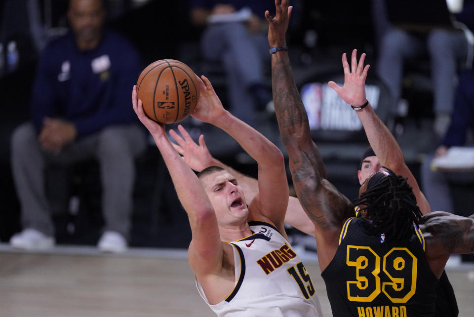 Denver Nuggets' Nikola Jokic (15) shoots over Los Angeles Lakers' Dwight Howard (39) during the first half of an NBA conference final playoff basketball game Sunday, Sept. 20, 2020, in Lake Buena Vista, Fla. (AP Photo/Mark J. Terrill)