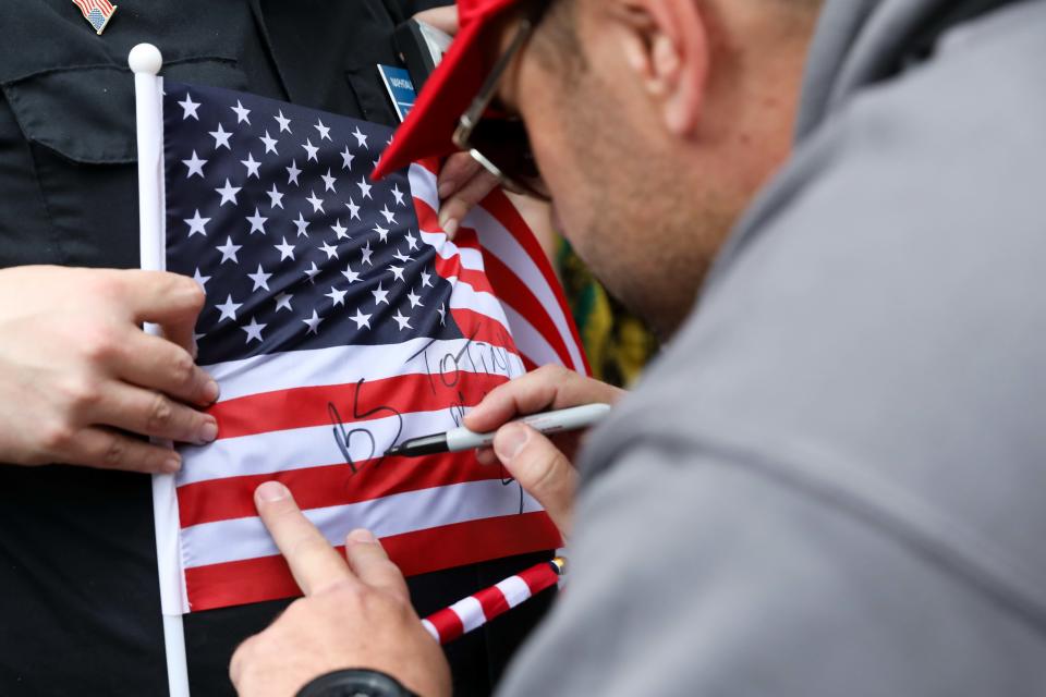 'Based Stickman' autographs a flag for an admirer.&nbsp;