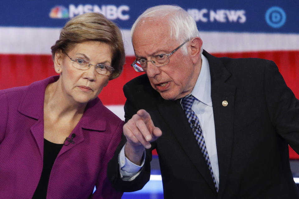 Democratic presidential candidates, Sen. Elizabeth Warren, D-Mass., left, and Sen. Bernie Sanders, I-Vt., talk during a Democratic presidential primary debate Wednesday, Feb. 19, 2020, in Las Vegas, hosted by NBC News and MSNBC. (AP Photo/John Locher)