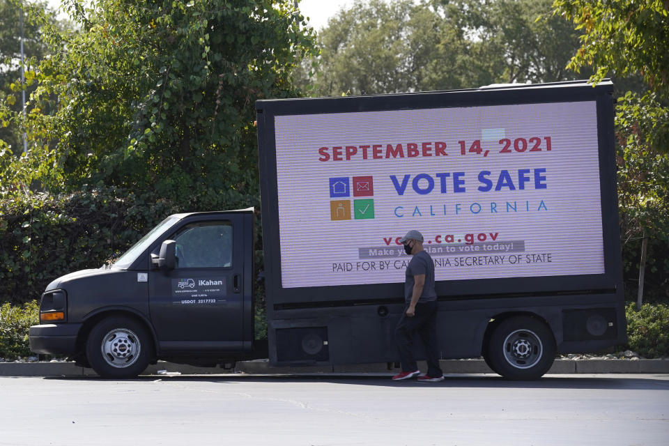 A truck with a digital sign reminding people of the Sept. 14 recall election is parked in a shopping center in Sacramento Calif., Thursday, Sept. 9, 2021. Democratic state lawmakers Sen. Steve Glazer and Assemblyman Marc Berman called for reforming the recall election requirements, Wednesday Sept. 15, 2021. This could include increasing the number of signatures to force a recall election, raising the standards to require malfeasance on the part of the office-holder and change the current process in which someone with a small percentage of votes could replace a sitting governor. (AP Photo/Rich Pedroncelli)