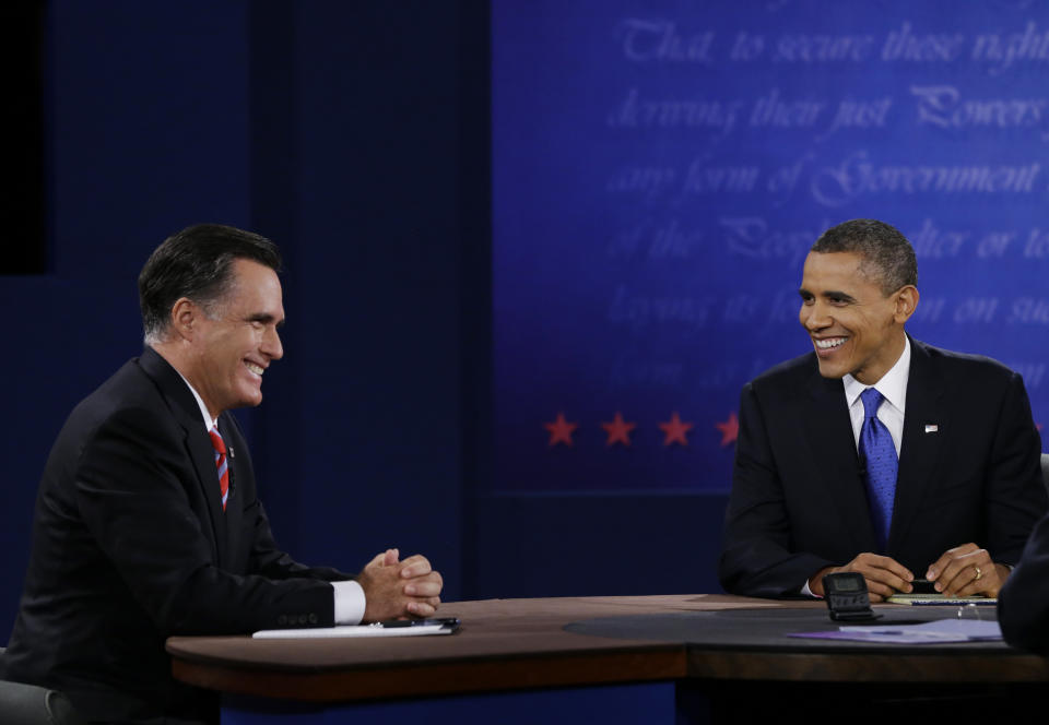 Republican presidential nominee Mitt Romney, left, and President Barack Obama laugh after being interrupted by moderator Bob Schieffer during the third presidential debate at Lynn University, Monday, Oct. 22, 2012, in Boca Raton, Fla. (AP Photo/David Goldman)