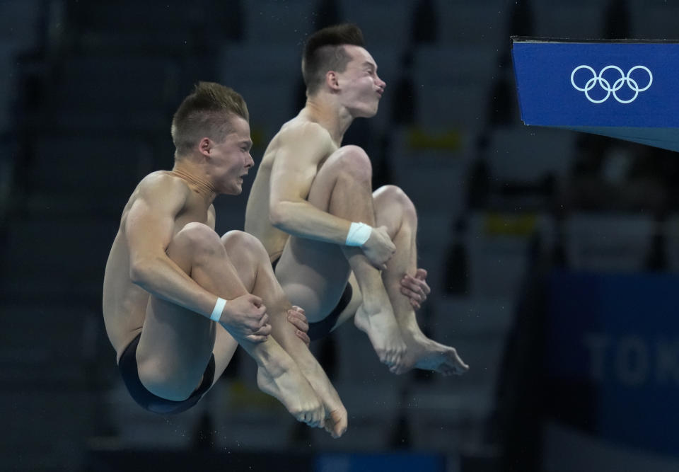 Oleh Serbin and Oleksii Sereda of Ukraine compete during the men's synchronized 10m platform diving final at the Tokyo Aquatics Centre at the 2020 Summer Olympics, Monday, July 26, 2021, in Tokyo, Japan. (AP Photo/Dmitri Lovetsky)