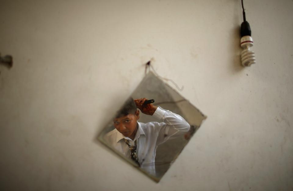 Young Palestinian groom Ahmed prepares before wedding party to bride Tala in town of Beit Lahiya