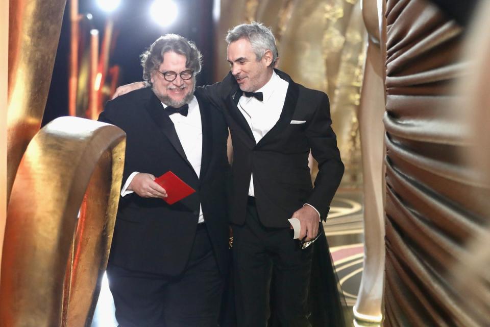 Director Guillermo del Toro (L) and winner of Best Foreign Language Film, Best Director and Best Cinematography for ‘Roma’, Alfonso Cuaron walk off stage during the 91st Annual Academy Awards (A.M.P.A.S. via Getty Images)