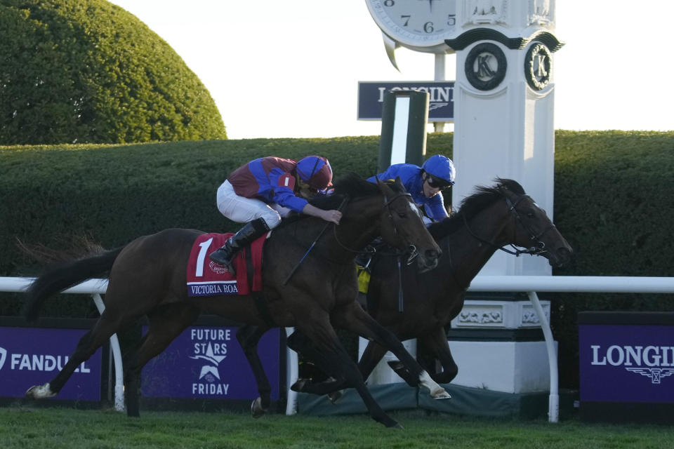 Ryan Moore rides Victoria Road (1) rides past William Buick rides Silver Knott (4) to win the Breeders' Cup Juvenile Turf race at the Keenelend Race Course, Friday, Nov. 4, 2022, in Lexington, Ky. (AP Photo/Jeff Roberson)