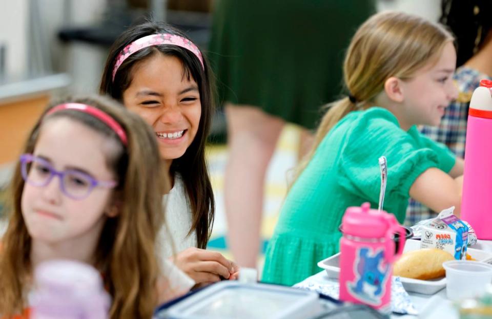 Combs Elementary School fourth grader Isbella Santos eats lunch during the Silver Tray lunch at Combs Elementary School in Raleigh, N.C., Thursday, May 16, 2024. At the Silver Tray Luncheon there is fancy silverware, cafeteria tables have tablecloths and centerpieces as the Enloe High School orchestra plays music to provide a fine dining experience. The dining experience was the culmination of a year-long effort to teach Combs’ students about the value of social etiquette and good manners.