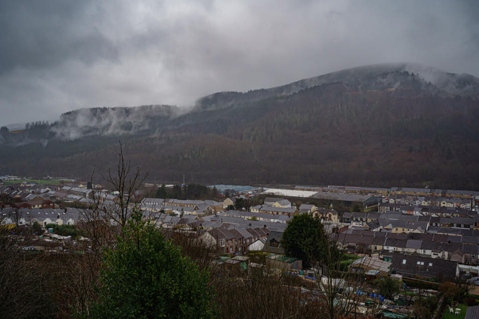 Clouds and rain cover the hills beyond the Welsh village of Treherbert at the head of the Rhondda Fawr valley as heavy rainfall in the area. Picture date: Sunday February 13, 2022.