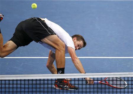 Vasek Pospisil of Canada tries to return the ball during his semi-final match against Switzerland's Roger Federer at the Swiss Indoors ATP tennis tournament in Basel October 26, 2013. REUTERS/Arnd Wiegmann