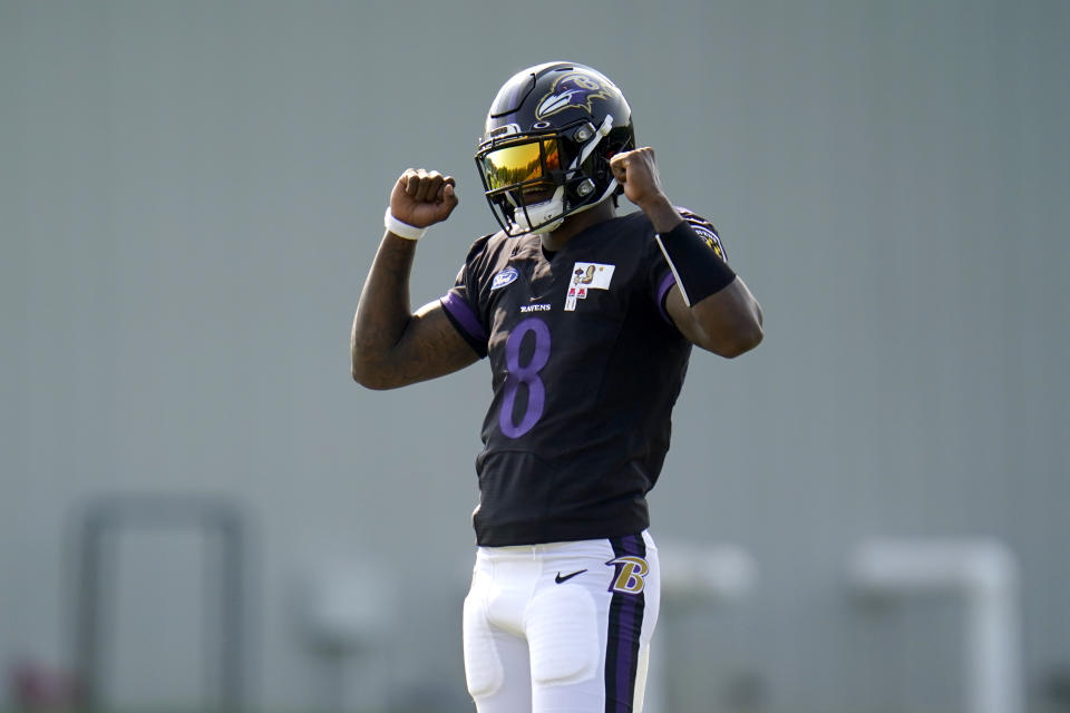 Lamar Jackson reacts with a double fist pump after running a drill in training camp.