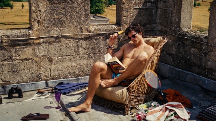 A man reads a book outside in Saltburn.