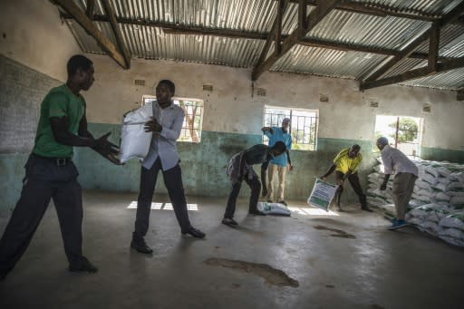 Volunteers help distribute bags of maize meal in Simumbwe where around 2.3 million people in Zambia are food-insecure