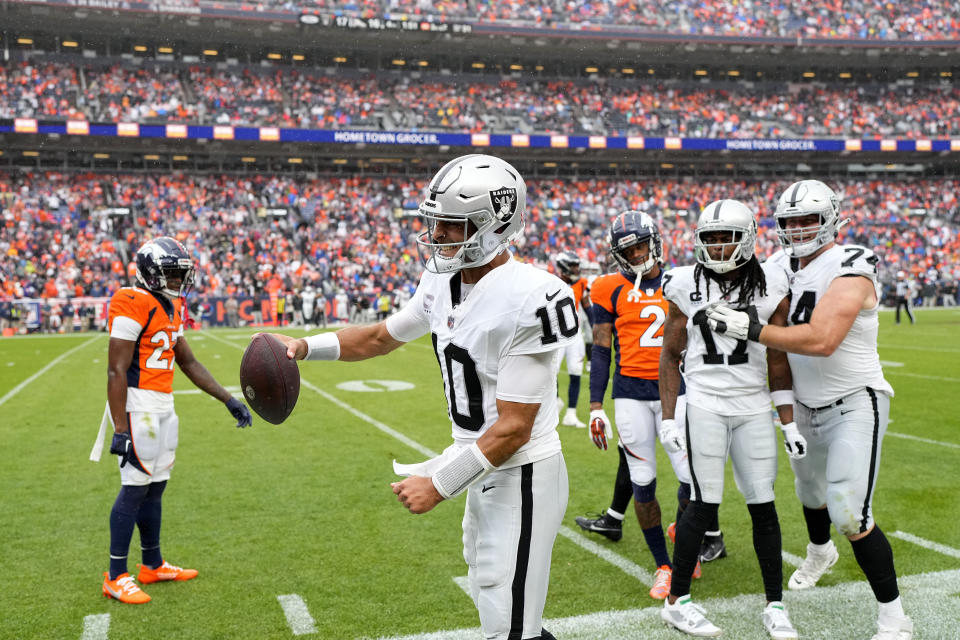 Las Vegas Raiders quarterback Jimmy Garoppolo (10) celebrates a first down during the second half of an NFL football game against the Denver Broncos, Sunday, Sept. 10, 2023, in Denver. (AP Photo/Jack Dempsey)