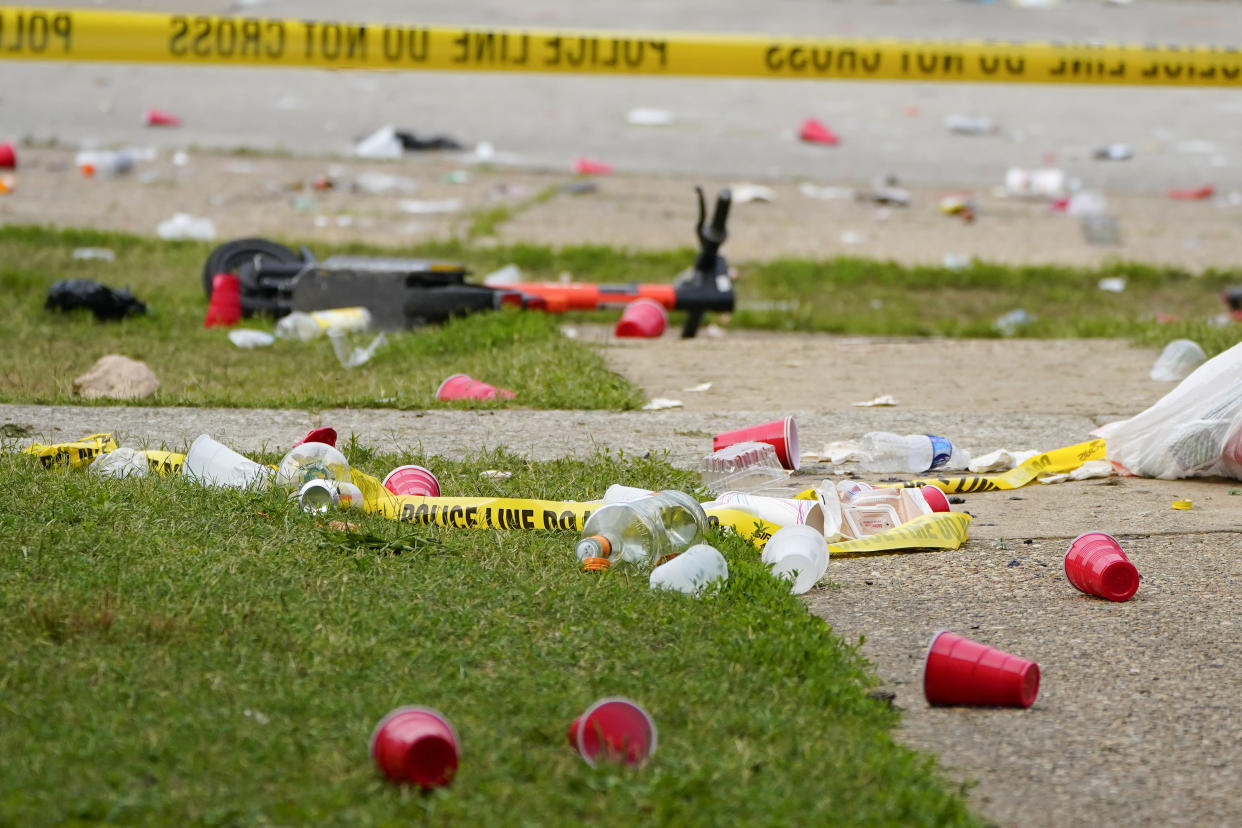 Party debris is seen behind police tape following a mass shooting in Baltimore on Sunday. (Julio Cortez/AP)