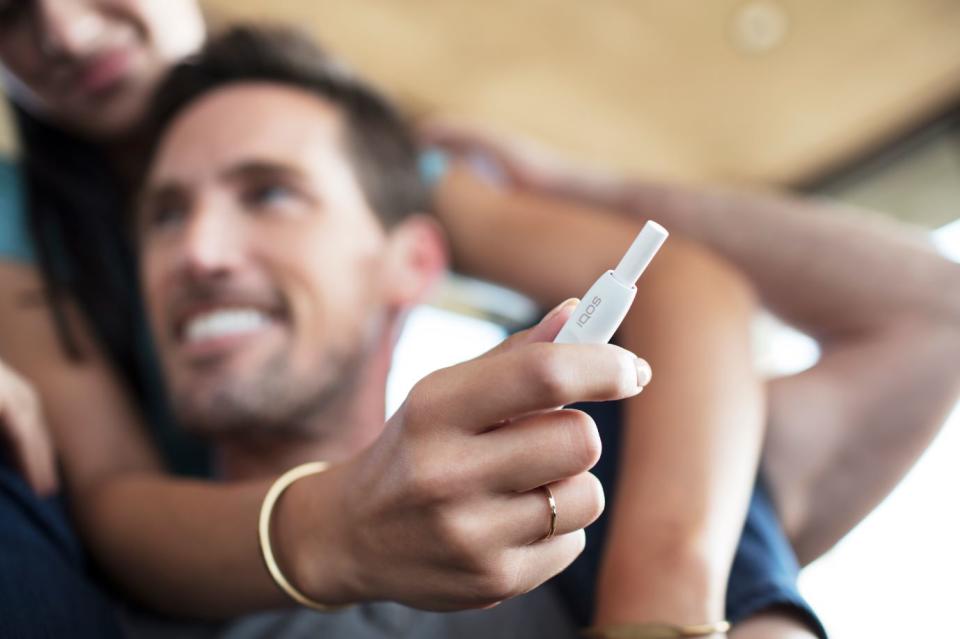 Couple with an IQOS electronic cigarette