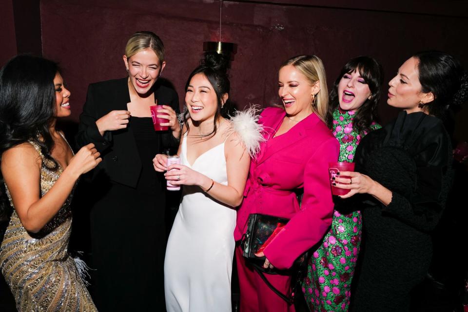 a group of women holding drinks
