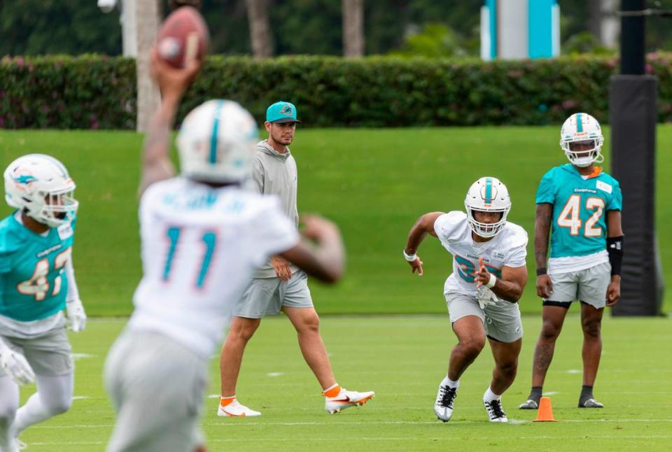 Miami Dolphins running back Chris Brooks (33) runs drills with wide receiver Cedrick Wilson Jr. (11) during team practice at the Baptist Health Training Complex on Wednesday, May 31, 2023, in Miami Gardens, Fla.