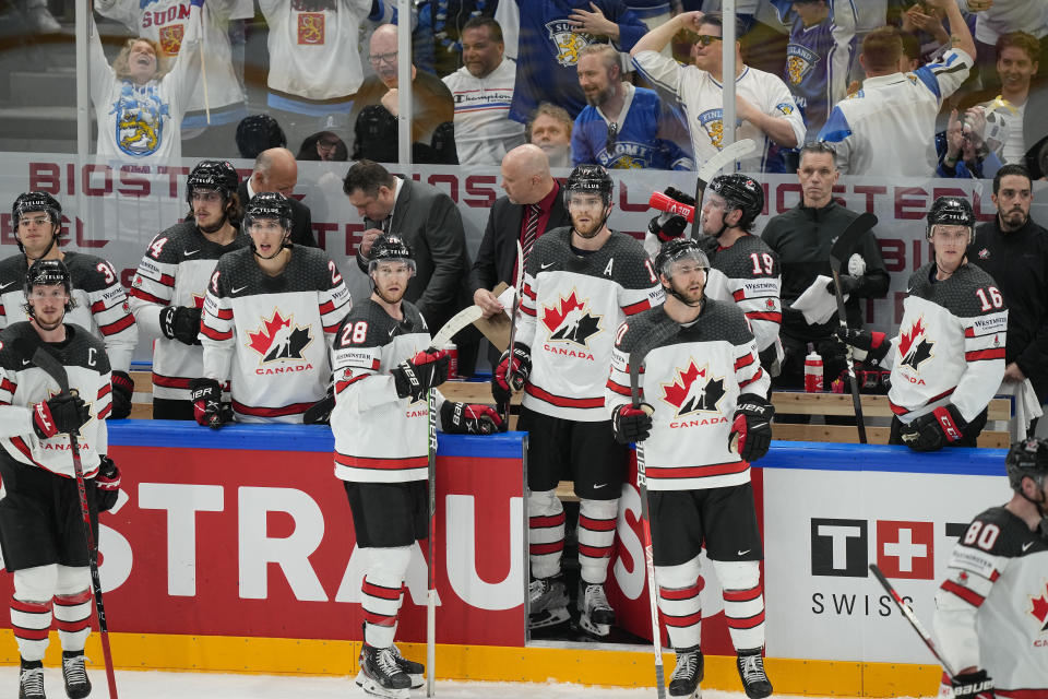 Team Canada looks on as Team Finland celebrates victory during the Hockey World Championship final match between Finland and Canada, Sunday May 29, 2022, in Tampere, Finland. Finland won 4-3 in overtime. (AP Photo/Martin Meissner)