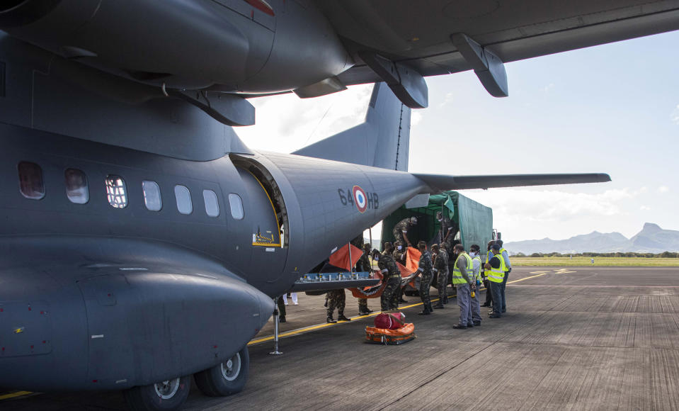 This photo provided by the French Defense Ministry shows a French military transport aircraft carrying pollution control equipment after landing in Mauritius island, Sunday Aug.9, 2020. The Indian Ocean island of Mauritius has declared a "state of environmental emergency" after the Japanese-owned ship that ran aground offshore days ago began spilling tons of fuel. (Gwendoline Defente/EMAE via AP)