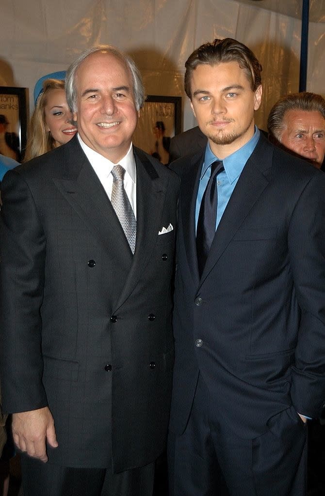 Two men in suits posing at a movie premiere