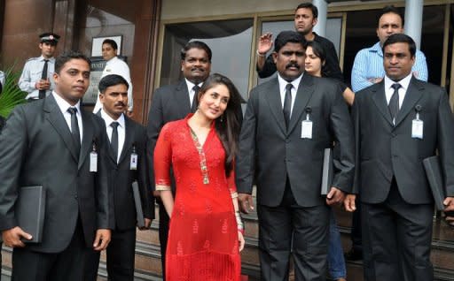 Indian Bollywood actress Kareena Kapoor (C) poses with celebrity bodyguards during the promotion of her new Hindi film 'Bodyguards' in Mumbai on August 31, 2011