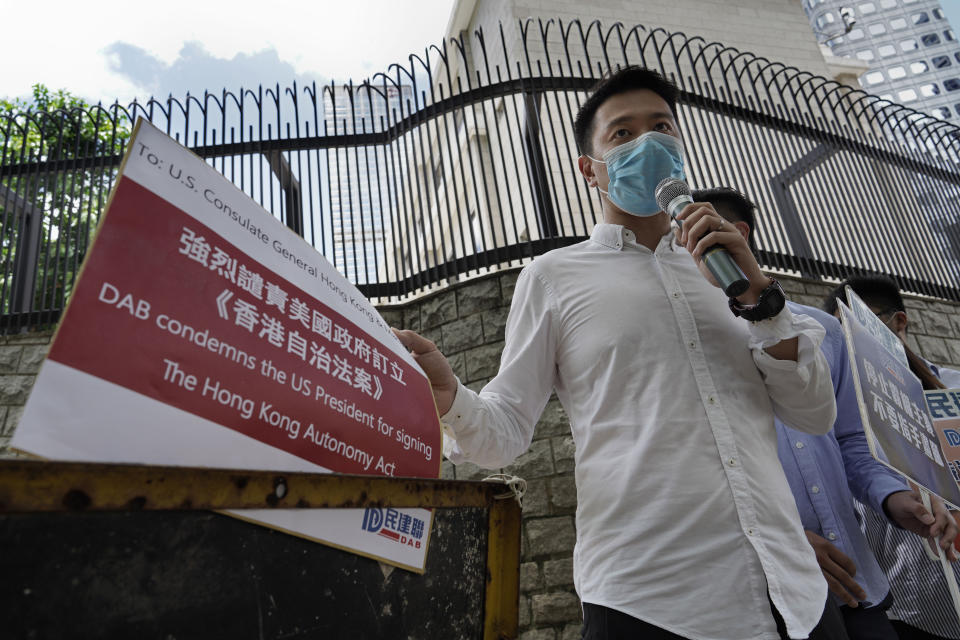 A Beijing supporter displays a placard during a protest against the U.S. sanctions outside the U.S. Consulate in Hong Kong Thursday, July 16, 2020. China has accused the U.S. of seeking to obstruct its development with moves to sanction officials who undermine local autonomy in Hong Kong. (AP Photo/Vincent Yu)