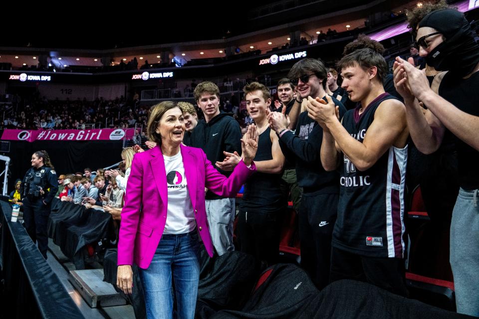 Iowa Gov. Kim Reynolds greets the Dowling Catholic student section during halftime during the Iowa high school state tournament championships at Wells Fargo Arena on Friday, March 1, 2024, in Des Moines.