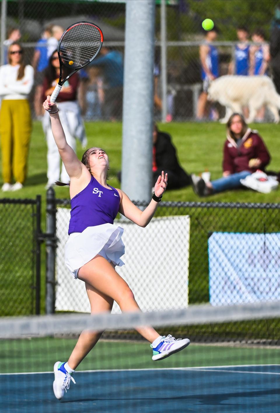 Bloomington South’s Maddie Santner hits an overhead during her No. 1 singles match against Bloomington North’s Keira Murphy during the tennis match at South on Thursday, April 25, 2024.
