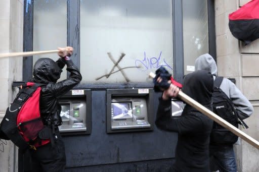 Protesters attack an ATM during a mass demonstration against government financial cuts in central London in 2011. European Union finance ministers struggled Wednesday to reach a deal on rules to shelter banks from future crises, as Britain and Sweden fought for the power to impose tougher defences