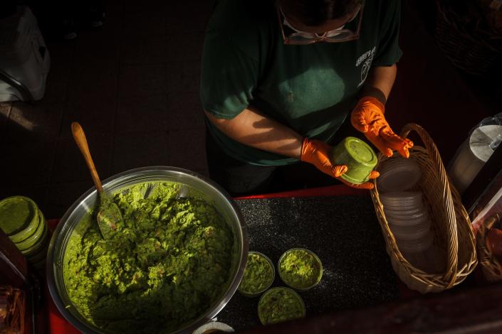 Alessia Sansom packages fresh guacamole at the West Palm Beach GreenMarket.