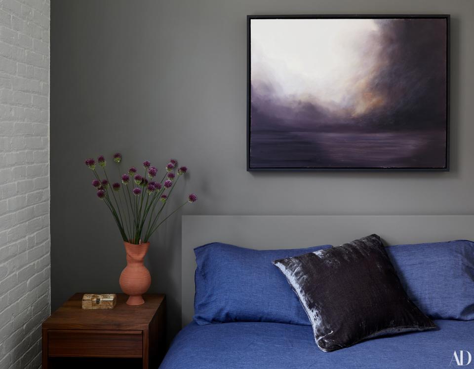 In the guest bedroom a painting by the artist (and Melling’s florist) Tom Borgese rests atop moody gray walls. “This is always the calm part of the house,” says Melling. Both she and Ashe prefer single-flower arrangements, though a preference for peonies and lilacs has evolved into a fondness of more sculptural florals and botanicals, in keeping with the new home’s aesthetic.