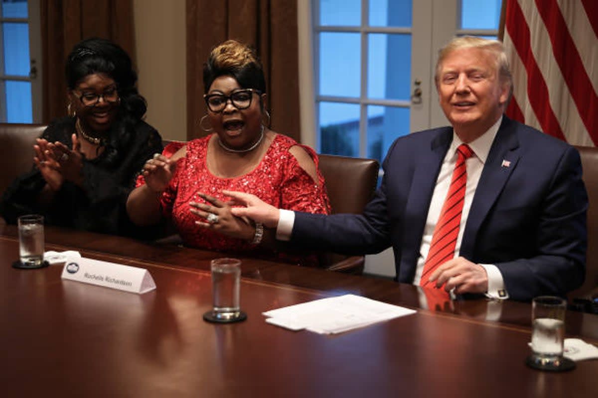 Donald Trump listens as Lynette ‘Diamond’ Hardaway and Rochelle ‘Silk’ Richardson praise him during a news conference and meeting with African American supporters in the Cabinet Room at the White House 27 February 2020  (Getty Images)