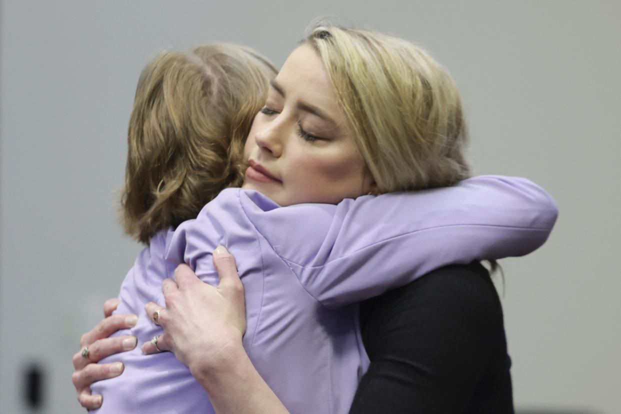 FILE - Actor Amber Heard hugs her lawyer Elaine Bredehoft after the verdict was read at the Fairfax County Circuit Courthouse in Fairfax, Va, on June 1, 2022. Heard says she doesn’t blame the jury that awarded Johnny Depp more than $10 million after a contentious six-week libel trial in her first post-verdict interview. She told Savannah Guthrie of “Today” in a clip airing Monday that she understood how the jury reached its conclusion and said Depp is a “beloved character and people feel they know him.” (Evelyn Hockstein/Pool via AP, File)