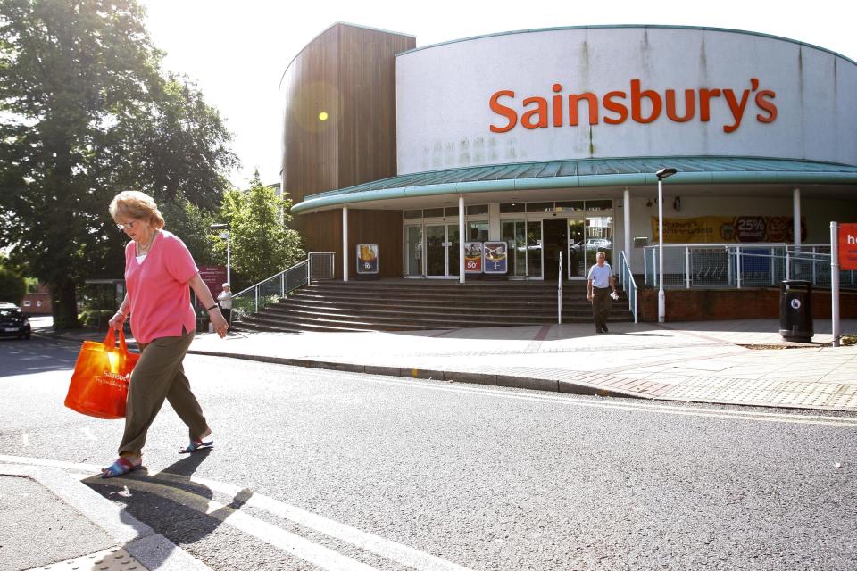 A woman, with her shopping, leaves a branch of Sainsbury's supermarket in Selsdon, south London, Wednesday, June 17, 2009. J. Sainsbury's PLC said Wednesday that it is seeking to raise 445 million pounds (US$732 million) in new capital to fund expansion of its UK supermarkets. Sainsbury's, Britain's third-largest supermarket group behind Tesco PLC and Wal-Mart's Asda stores, said it would place 225 million pounds of new shares and offer 190 million pounds of convertible bonds to support its plan to expand store space by 15 percent in the next two years. The announcement came as Sainsbury's said comparable sales were up 2.5 percent in the 13 weeks ending June 13, or up 7.8 percent excluding saes of fuel and sales tax. (AP Photo/Sang Tan)