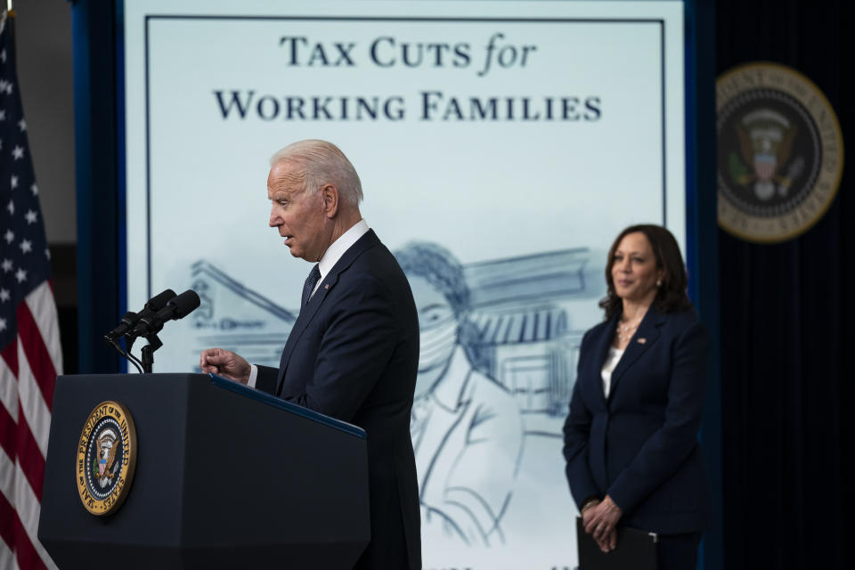 FILE - Vice President Kamala Harris listens as President Joe Biden speaks during an event to mark the start of monthly Child Tax Credit relief payments, in the South Court Auditorium on the White House complex, July 15, 2021, in Washington. (AP Photo/Evan Vucci, File)