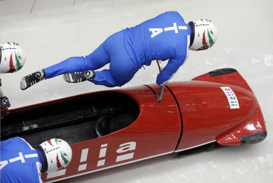 The team from Italy ITA-1, piloted by Simone Bertazzo, start a run during the men's four-man bobsled training at the 2014 Winter Olympics, Wednesday, Feb. 19, 2014, in Krasnaya Polyana, Russia. 