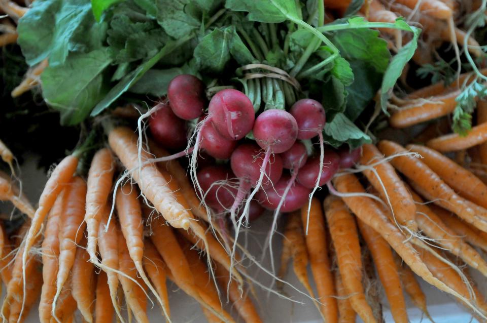 Fresh carrots and radishes from Pariah Dog Farm in Falmouth on display at Saint Barnabas's Episcopal Church, which is hosting the winter Falmouth Farmers’ Market. Those sweet carrots are even sweeter grated into batter for carrot cake.