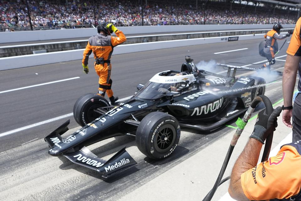 Pato O'Ward, of Mexico, makes a pit stop during the Indianapolis 500 auto race at Indianapolis Motor Speedway, Sunday, May 28, 2023, in Indianapolis. (AP Photo/Darron Cummings)