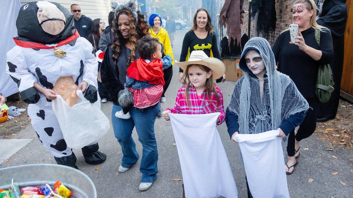 People trick-or-treating walk through Spook Alley behind homes on Harrison Boulevard in Boise during Halloween on Oct 31, 2022.