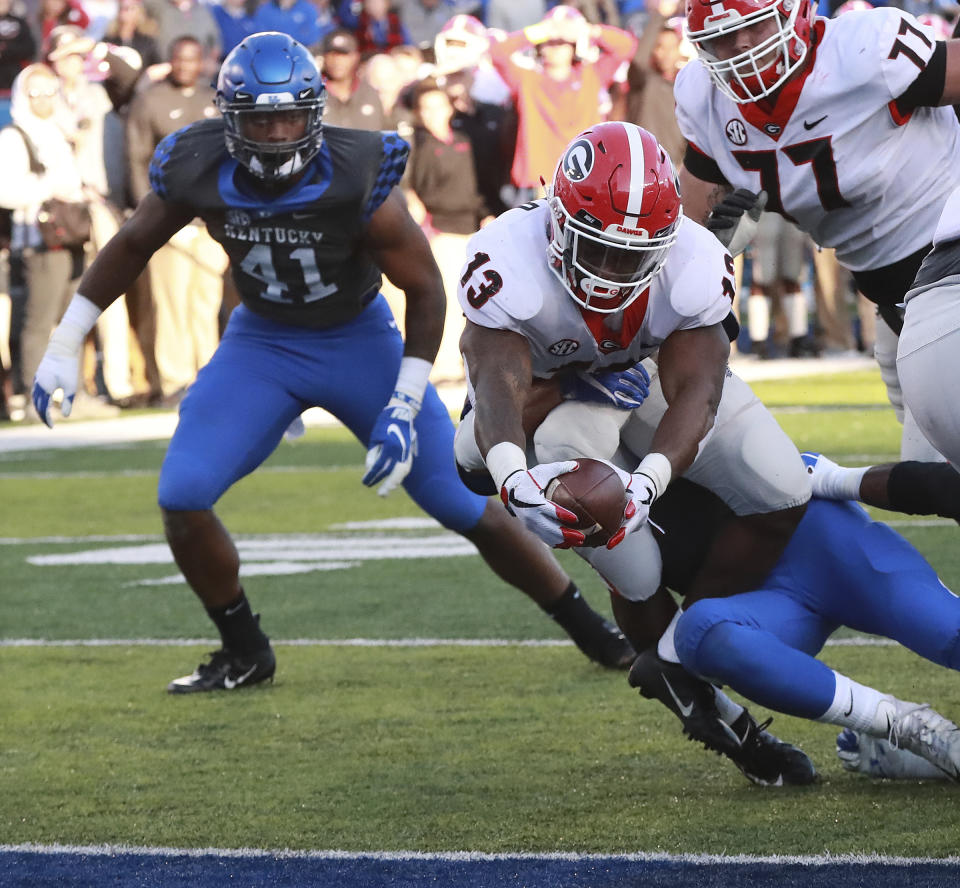 Georgia tailback Elijah Holyfield stretches for the goal line for a touchdown during the third quarter in a NCAA college football game on Saturday, Nov. 3, 2018, in Lexington, Ky. (Curtis Compton/Atlanta Journal-Constitution via AP)