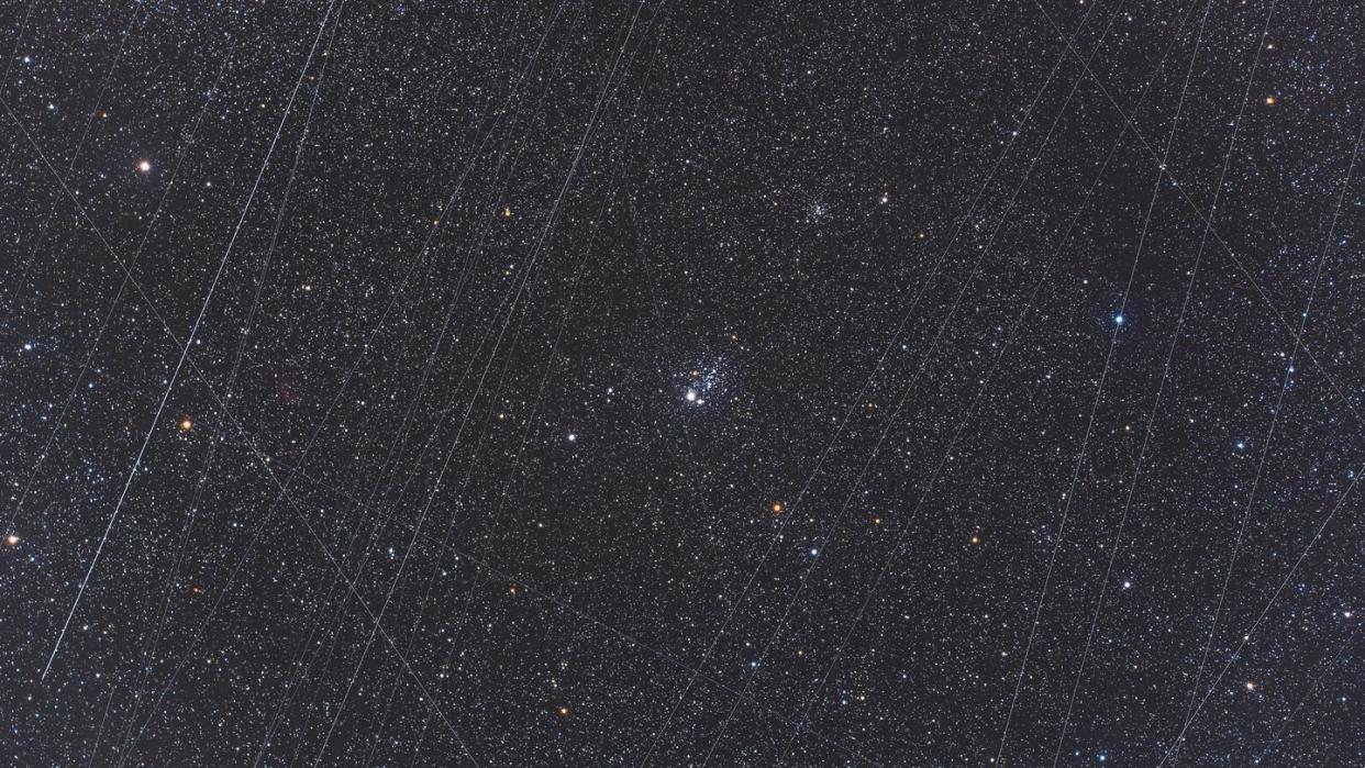 ngc 457, the owl cluster in cassiopeia, with accumulated satellite trails