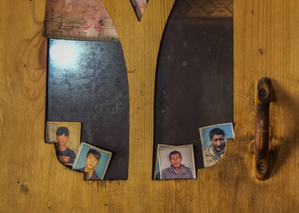 Photographs of some migrant villagers line a cupboard inside a house of a nomad in remote Kharnak village in the cold desert region of Ladakh, India, Saturday, Sept. 17, 2022. Thousands of Ladakh nomads known for their unique lifestyle in one of the most hostile landscapes in the world have been at the heart of changes caused by global warming, compounded by border conflict and shrinking grazing land. (AP Photo/Mukhtar Khan)