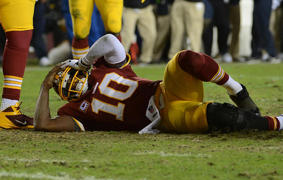 LANDOVER, MD - JANUARY 06: Washington Redskins quarterback Robert Griffin III (10) stays on the ground after injuring his knee in the fourth quarter of the first round NFC playoff game between the Washington Redskins and the Seattle Seahawks at FedEd Field in Landover, Md., on Sunday, January 6, 2013. (Photo by Toni L. Sandys/The Washington Post via Getty Images)