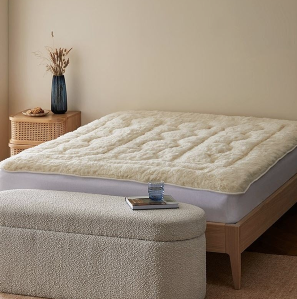 MiniJumbuk Sleep Therapy Wool Mattress Topper in a minimalist bedroom