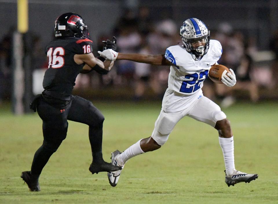 Bartram Trail's Julian Porter (22) scrambles to avoid Creekside's Bruno Alves (16) during late third quarter action. Creekside High School football team hosted Bartram Trail at their Knights Lane campus Friday night, October 14, 2022. The Bartram Bears came away with a 59 to 27 victory over the Creekside Knights.