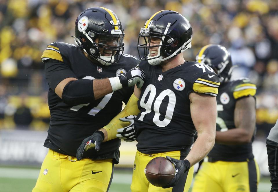 Pittsburgh Steelers defensive end Cameron Heyward (97) and outside linebacker T.J. Watt (90) celebrate after a fumble recovery by Watt against the Tennessee Titans during the fourth quarter at Heinz Field.