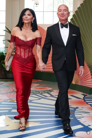 <p>Tasos Katopodis/Getty</p> Amazon founder Jeff Bezos (R) and his fiancee Lauren Sanchez arrive at the White House for a state dinner on April 10