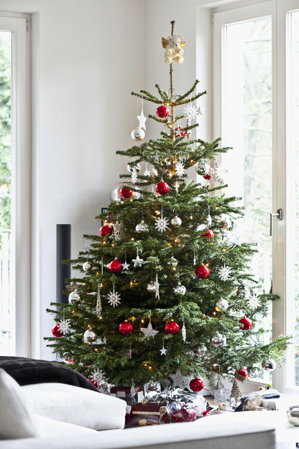 Real Christmas tree with decorations in a living room