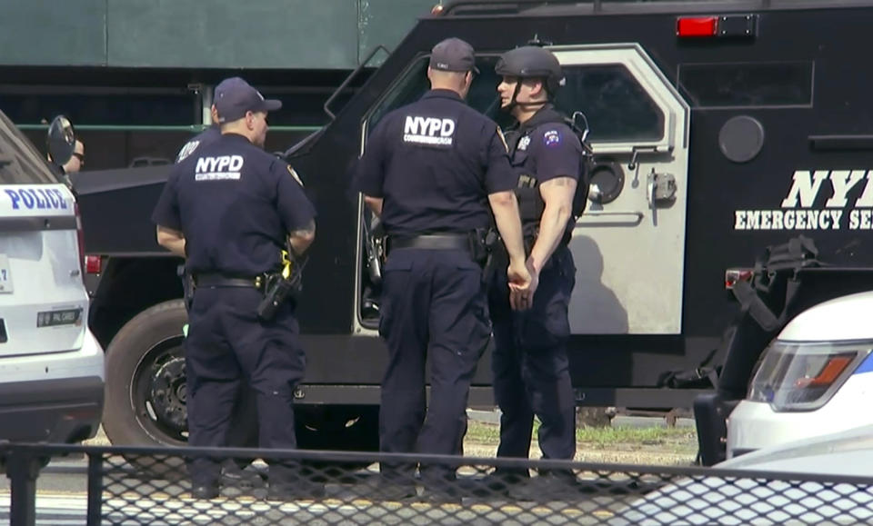 <p>In this image taken from video, officers from the New York Police Department’s Emergency Services Unit hold a conversation by an armored vehicle outside Bronx Lebanon Hospital in New York, after a gunman opened fire there on Friday, June 30, 2017. (AP Photo/Joseph Frederick) </p>