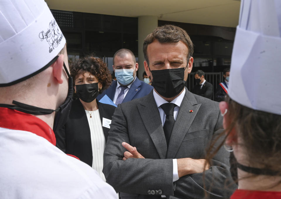 French President Emmanuel Macron talks with cooking students, Tuesday June 8, 2021 at the Hospitality school in Tain-l'Hermitage, southeastern France. (Philippe Desmazes, Pool via AP)