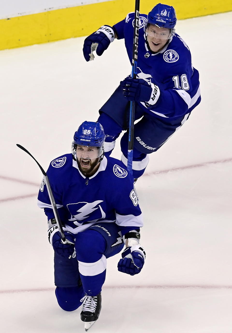 Tampa Bay Lightning right wing Nikita Kucherov (86) celebrates his goal with teammate Ondrej Palat (18) during the first period of an NHL hockey Stanley Cup playoff gsme in Toronto, Thursday, Aug. 13, 2020. (Frank Gunn/The Canadian Press via AP)